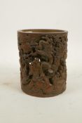 A Chinese carved and pierced bamboo brush pot decorated with Lohan and auspicious animals, 6" high