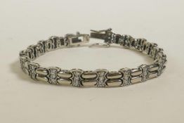 A silver and cubic zirconium set line bracelet, 7" long