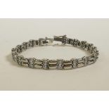 A silver and cubic zirconium set line bracelet, 7" long