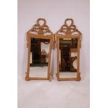 A pair of giltwood pier glasses, with ribbon and rope decoration, A/F losses to base mouldings,