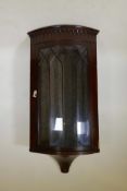 A mahogany museum hanging bowfront corner display cabinet, with arched top and single astragal
