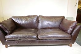 A contemporary brown leather two seater sofa, 84" wide