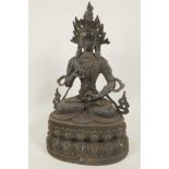 A Chinese bronze figure of Quan Yin seated in meditation on a double lotus throne, 15" high