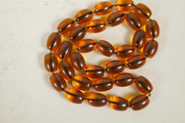 A long faux amber bead necklace, 34" long