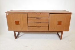 A 1970s Europa furniture sideboard with two cupboards flanking a flight of four drawers, 59" x