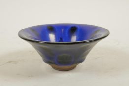 A Chinese Jian ware pottery bowl with a blue petal style glaze, 5½" diameter