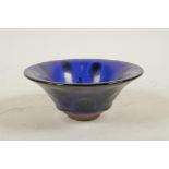 A Chinese Jian ware pottery bowl with a blue petal style glaze, 5½" diameter