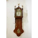 A C19th German walnut weight driven wall clock with arched and painted dial, sun and moon phase,