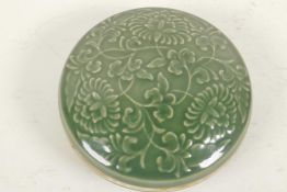 A Chinese green glazed porcelain trinket box with embossed flower decoration (signed), 5" diameter