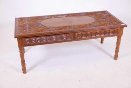 An Oriental carved hardwood low table with two frieze drawers, 22" x 49" x 19"