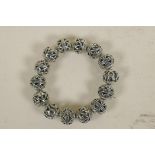 A Chinese pierced metal bangle (14 beads)