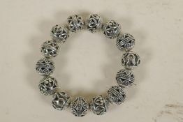 A Chinese pierced metal bangle (14 beads)