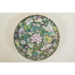 A Chinese famille noire porcelain cabinet plate decorated with Asiatic flowers, 6 character mark