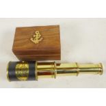 A three draw brass telescope, 7¼" long extended, in a fitted hardwood box