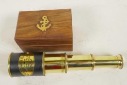 A three draw brass telescope, 7¼" long extended, in a fitted hardwood box