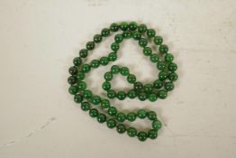 A string of jade beads, 33" long