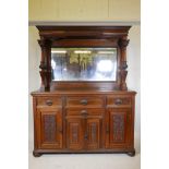 A Victorian walnut mirror back sideboard with carved and turned columns, scrolling panelled doors,