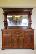A Victorian walnut mirror back sideboard with carved and turned columns, scrolling panelled doors,
