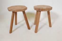 A pair of blond oak milking stools, 13" high