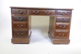 An Edwardian walnut nine drawer twin pedestal desk with swan neck handles, 29" x 48" x 26"