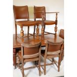 A Victorian mahogany wind out dining table on turned and carved legs, with a single leaf, and six
