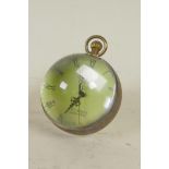 A brass and glass ball desk clock, 2¼" diameter