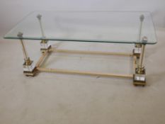 A brass and lucite coffee table with a glass top, possibly ex Harrods, A/F glass chipped, 47" x 24",