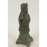 A Chinese bronze figure of a standing Immortal in fine robes, 10" high