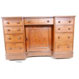 A C19th mahogany breakfront kneehole desk with a tooled leather inset top, central cupboard