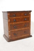 A C19th rosewood veneered miniature chest of four long drawers, 12" x 12" x 8"