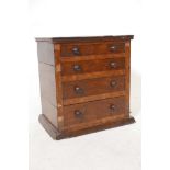 A C19th rosewood veneered miniature chest of four long drawers, 12" x 12" x 8"