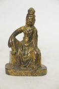 A bronze figure of a seated Buddhistic figure, with worn gilt patination, 5" high