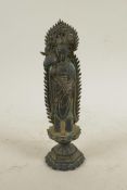 A Chinese bronze figure of Quan Yin standing on a lotus throne holding a ruyi, 8½" high