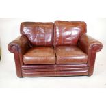 A Thomas Lloyd two seater leather sofa, 58" wide