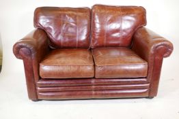 A Thomas Lloyd two seater leather sofa, 58" wide