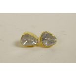 A pair of silver gilt and uncut diamond stud earrings