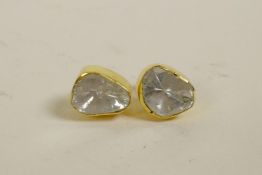 A pair of silver gilt and uncut diamond stud earrings