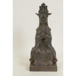 A Chinese bronze figure of Guan Yin seated on a plinth decorated with calligraphy, 9½" high