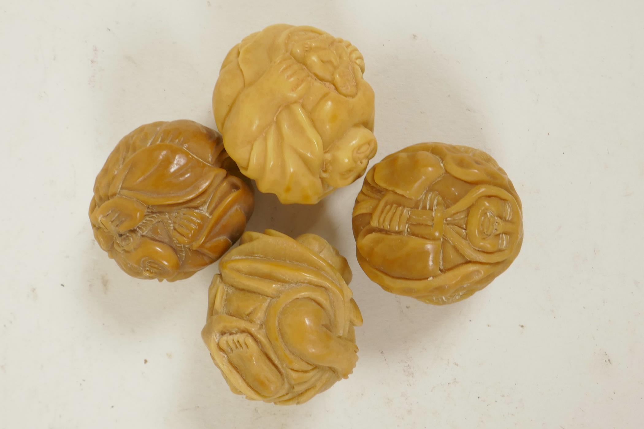 Four Oriental nuts carved with various figures, 1¼" - Image 2 of 2