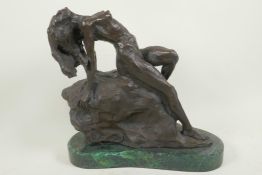 A stylised bronze figure of a nude female posed on a rock, 11" high