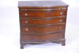 A mahogany serpentine fronted four drawer chest, with brush slide, raised on ogee bracket feet,