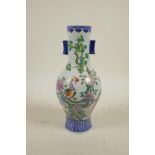 A Chinese polychrome porcelain vase with two lug handles, decorated in enamels depicting Asiatic