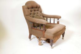 A Victorian mahogany framed upholstered armchair with turned arm and front supports on later