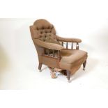 A Victorian mahogany framed upholstered armchair with turned arm and front supports on later