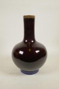 A Chinese burgundy flambe glazed porcelain bottle vase, 4 character mark to base, 13½" high