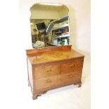 An Art Deco three quarter veneered walnut dressing table with mirror back, two short drawers over