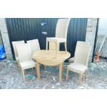 A contemporary light oak extending drop leaf dining table and six 'Castle Loom' dining chairs,