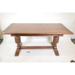 A plank top oak refectory table with bulbous carved end supports, 66" x 33½", 30" high