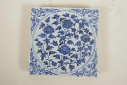 A Chinese blue and white porcelain temple tile with floral decoration, 7½" x 7½"