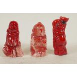 Three Tibetan carved coral Buddhist figurines, 2¼" long